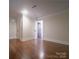 Open living room with wood floors, trim work, natural light and views to other rooms through doors at 317 Belwood Dr, Belmont, NC 28012