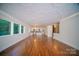 Expansive living room with gleaming hardwood floors and decorative ceiling, flowing into kitchen at 317 Belwood Dr, Belmont, NC 28012