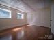 Bright, open living room with wood floors, paneled ceiling, trim work, natural light, and closets at 317 Belwood Dr, Belmont, NC 28012