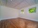 Bright, open living room with wood floors, paneled ceiling, trim work, and natural light through windows at 317 Belwood Dr, Belmont, NC 28012