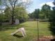 Spacious backyard with mature trees and shed, ideal for outdoor play and gardening at 443 Silversmith Ln # 16, Charlotte, NC 28270