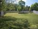 Expansive backyard with lush green grass, shed, and mature trees, perfect for outdoor enjoyment at 443 Silversmith Ln # 16, Charlotte, NC 28270