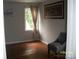 Bedroom showcasing wood floors, a large window, wall art and a chair at 443 Silversmith Ln # 16, Charlotte, NC 28270