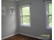 Bedroom featuring wood floors, windows and a modern kid-themed wall decor at 443 Silversmith Ln # 16, Charlotte, NC 28270