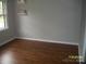 Bedroom featuring dark wood floors, a bright window and storage shelving at 443 Silversmith Ln # 16, Charlotte, NC 28270