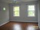 Light-filled bedroom with two windows and vinyl flooring at 443 Silversmith Ln # 16, Charlotte, NC 28270