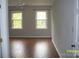 Bright bedroom featuring gleaming wood floors, a ceiling fan, and large windows at 443 Silversmith Ln # 16, Charlotte, NC 28270