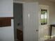 Hallway leads to a bathroom with a vanity, with an exit door with glass at 443 Silversmith Ln # 16, Charlotte, NC 28270