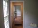 Hallway with hardwood floors leads to a room with natural light and an aquarium at 443 Silversmith Ln # 16, Charlotte, NC 28270