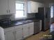 Well-lit kitchen features stainless steel appliances, window, and white cabinets at 443 Silversmith Ln # 16, Charlotte, NC 28270