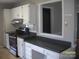 Kitchen with white cabinets and desk space that looks into another room at 443 Silversmith Ln # 16, Charlotte, NC 28270