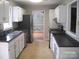 Well-lit kitchen features white cabinets and stainless steel appliances at 443 Silversmith Ln # 16, Charlotte, NC 28270