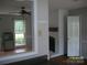 View from kitchen to living room with fireplace, aquarium, and windows at 443 Silversmith Ln # 16, Charlotte, NC 28270