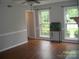 Bright living room with hardwood floors, wainscoting, and large windows at 443 Silversmith Ln # 16, Charlotte, NC 28270