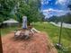 Spacious backyard featuring a brick patio, outdoor furniture, a slide, and lush green grass at 443 Silversmith Ln, Charlotte, NC 28270