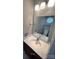 Modern bathroom vanity with granite countertop, stylish fixtures, and a decorative mirror reflecting a toilet and window at 443 Silversmith Ln, Charlotte, NC 28270