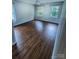 Bedroom with wood-look flooring, a ceiling fan, and natural light from two windows at 443 Silversmith Ln, Charlotte, NC 28270