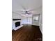 Inviting living room with a classic fireplace, ceiling fan, and sliding doors to the backyard at 443 Silversmith Ln, Charlotte, NC 28270