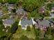 An aerial view of a home showcasing landscaping, mature trees, and a private driveway at 7605 Berryfield Ct, Waxhaw, NC 28173