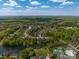 Aerial view of a community featuring a pond, tennis courts, a pool, and walking trails at 7605 Berryfield Ct, Waxhaw, NC 28173