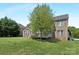 Brick home's backyard view features a deck, lush lawn, and mature tree at 7605 Berryfield Ct, Waxhaw, NC 28173