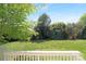 View from the deck of lush green lawn with mature trees offering shade at 7605 Berryfield Ct, Waxhaw, NC 28173