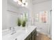 Bright bathroom features a double sink vanity, tiled floor, and a shower-tub combo at 7605 Berryfield Ct, Waxhaw, NC 28173