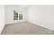 Empty bedroom with carpet flooring and a window providing natural light at 7605 Berryfield Ct, Waxhaw, NC 28173