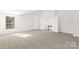 Spacious bedroom with large window and neutral carpet leads to an upper level at 7605 Berryfield Ct, Waxhaw, NC 28173
