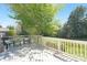 Relax on the inviting gray deck with two chairs, a side table, and lush green foliage at 7605 Berryfield Ct, Waxhaw, NC 28173