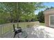 Relax on the inviting white deck with a dark chair, side table, and lush green foliage at 7605 Berryfield Ct, Waxhaw, NC 28173