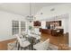 Open-concept dining room with chandelier, leading to kitchen with island at 7605 Berryfield Ct, Waxhaw, NC 28173