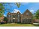 Beautiful brick home with manicured lawn, classic shutters, and arched entryway, offering timeless curb appeal at 7605 Berryfield Ct, Waxhaw, NC 28173