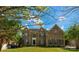A stately brick home stands with a manicured lawn, large windows, and a symmetrical design creating a welcoming façade at 7605 Berryfield Ct, Waxhaw, NC 28173