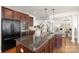 Kitchen featuring dark cabinets, granite countertops, and stainless steel appliances at 7605 Berryfield Ct, Waxhaw, NC 28173