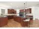 Gourmet kitchen boasting dark wood cabinetry and a large center island with seating at 7605 Berryfield Ct, Waxhaw, NC 28173