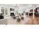 Open-concept living room with fireplace flows into kitchen, featuring hardwood floors and natural light at 7605 Berryfield Ct, Waxhaw, NC 28173