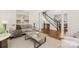 Spacious living room with hardwood floors, stylish furniture, and staircase access, offering a welcoming atmosphere at 7605 Berryfield Ct, Waxhaw, NC 28173