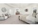 Bright main bedroom features a tray ceiling, neutral walls, carpeted floor, and natural light from white-curtained windows at 7605 Berryfield Ct, Waxhaw, NC 28173