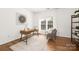 Bright home office with large window, wooden desk, and comfortable seating at 7605 Berryfield Ct, Waxhaw, NC 28173