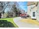 A spacious backyard offers a patio with outdoor seating, a lawn, and mature trees at 7925 Woodmere Dr, Harrisburg, NC 28075