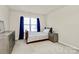 Well-lit bedroom featuring a bed, dresser, and ample natural light from the window at 7925 Woodmere Dr, Harrisburg, NC 28075