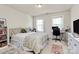 Inviting bedroom with a cozy bed, natural light, and a functional desk area at 7925 Woodmere Dr, Harrisburg, NC 28075