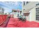 Exterior deck with red railings, chairs and table at 7925 Woodmere Dr, Harrisburg, NC 28075