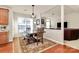 View of a dining room with a wooden table and chairs next to an open living area at 7925 Woodmere Dr, Harrisburg, NC 28075