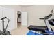 Bright home gym with view into the home, featuring a treadmill and exercise bike at 7925 Woodmere Dr, Harrisburg, NC 28075