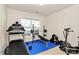 Bright home gym featuring treadmill, weights, weight bench, exercise bike and natural light from the large window at 7925 Woodmere Dr, Harrisburg, NC 28075