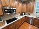 Kitchen featuring stainless steel appliances, wood floors, and counter space at 7925 Woodmere Dr, Harrisburg, NC 28075