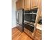 Kitchen showcasing stainless steel refrigerator and built-in double ovens at 7925 Woodmere Dr, Harrisburg, NC 28075