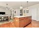 View of kitchen island next to dining room table and an open living area at 7925 Woodmere Dr, Harrisburg, NC 28075